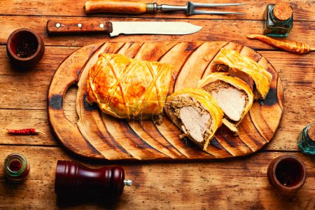 Photo for Popular delicious meat food is wellington meat, meat wrapped in dough. British food, old wooden table - Royalty Free Image