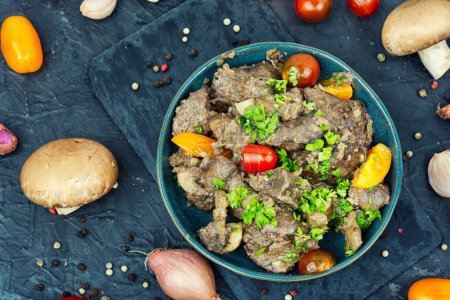 Photo for Spicy chicken liver stewed with mushrooms and tomatoes. Georgian recipe, top view - Royalty Free Image
