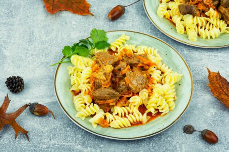 Photo for Hungarian goulash cooked with beef meat and served with macaroni on a plate - Royalty Free Image