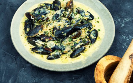 Photo for Cooked appetizing mussels in a creamy sauce - Royalty Free Image