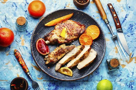 Photo for Juicy meat steak grilled in oranges. Meat in citrus marinade. Top view - Royalty Free Image