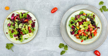 Photo for Salad with greens, pepper, red lettuce and cucumber, decorated with pomegranate. Green vegan salad - Royalty Free Image