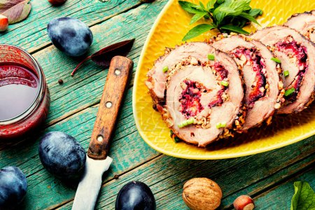 Photo for Sliced meatloaf stuffed with plums. Autumn meat recipe. Roast pork with prunes - Royalty Free Image
