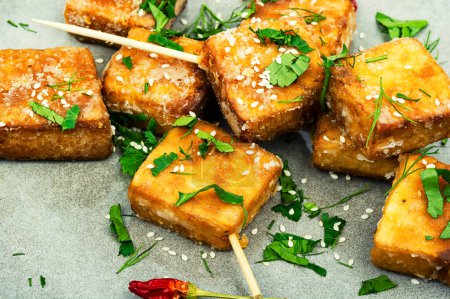 Photo for Skewers with roasted tofu cheese with and sesame seeds. Close up - Royalty Free Image