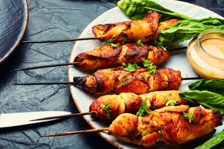Photo for Appetizing chicken meat, chicken breast roasted on wooden skewers. - Royalty Free Image