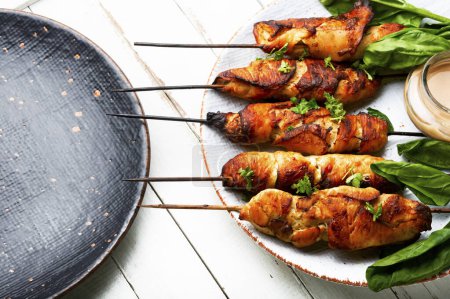 Photo for Tasty chicken meat, chicken breast roasted on wooden skewers. Kebabs - Royalty Free Image