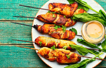 Photo for Chicken kebab skewers on a plate, chicken breast fried on wooden skewers. - Royalty Free Image