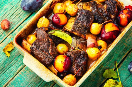 Photo for Lamb ribs baked with pear and plum. - Royalty Free Image