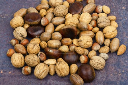 Photo for Walnut, chestnut, almond, hazelnut on the table.Healthy food and snacks - Royalty Free Image