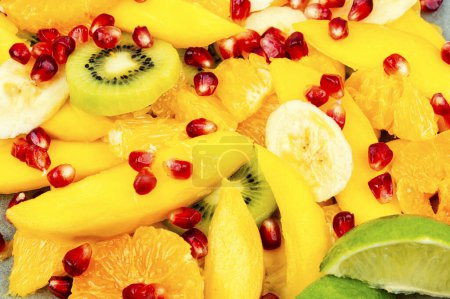 Foto de Vitamin fresh salad of mango, citrus, banana and berries. Close up - Imagen libre de derechos