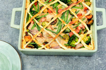 Photo for Meat pie with brussels sprouts, pumpkin and broccoli in baking dish. Autumn pie. - Royalty Free Image