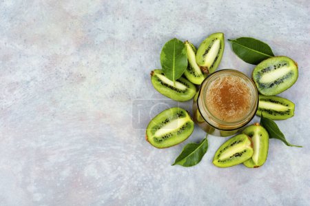 Photo for Delicious kiwi jam in a glass jar. Top view, copy space. - Royalty Free Image