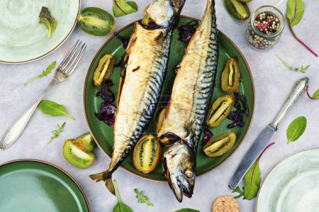 Photo for Whole cooking mackerel fish with kiwi fruits. Seafood - Royalty Free Image