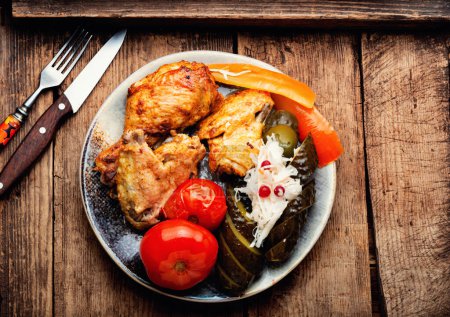 Photo for Roasted chicken pieces with marinated vegetables. Rustic style - Royalty Free Image