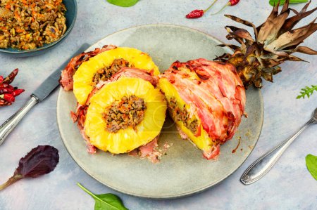 Photo for Delicious baked pineapple with spicy meat filling, wrapped bacon - Royalty Free Image