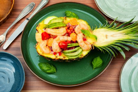 Photo for Salad in pineapple with rice, vegetables and prawns on the table - Royalty Free Image