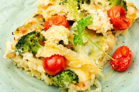 Photo for Homemade potato casserole with broccoli and tomatoes. Vegetarian food. - Royalty Free Image