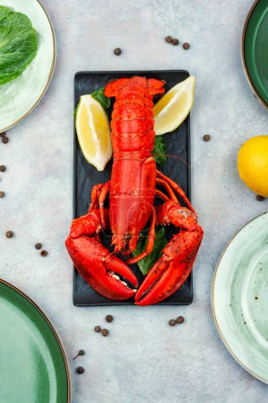 Foto de Cooked lobster with lemon on a tray. Seafood. Top view. - Imagen libre de derechos