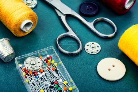 Photo for Home sewing kit, scissors, pin, colorful thread and buttons. Needlework concept - Royalty Free Image