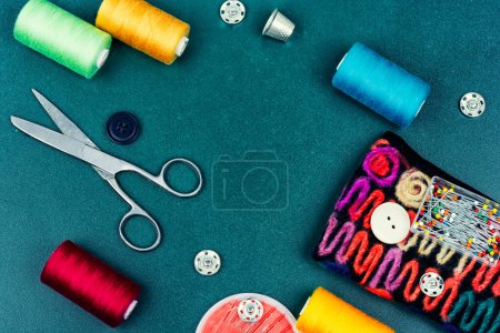 Photo for Home sewing kit, scissors, color threads, needles and buttons. Needlework concept - Royalty Free Image