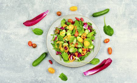 Photo for Spring salad of tomatoes, cucumbers, peppers and lettuce. Diet menu - Royalty Free Image