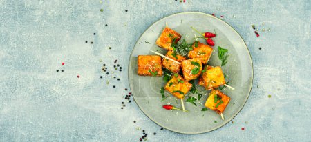 Photo for Grilled tofu cheese skewers on the plate. Copy space - Royalty Free Image