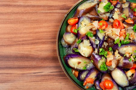 Photo for Warm purple eggplant, tomato and garlic salad. Salad of baked vegetables. Copy space for text - Royalty Free Image