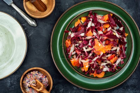 Photo for Fresh red chicory salad with orange on a plate. Vegetarian meal - Royalty Free Image