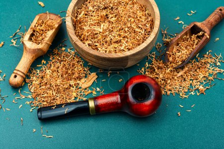Photo for Smoking tobacco and classic wooden smoking pipe on the table. - Royalty Free Image
