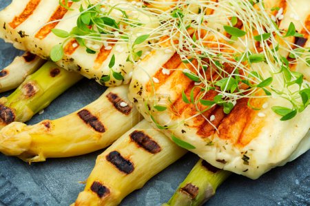 Photo for White asparagus and fried halloumi cheese with sesame seeds. Close up - Royalty Free Image
