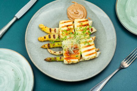 Photo for Healthy dish of white asparagus, grilled halloumi cheese decorated with microgreens. - Royalty Free Image