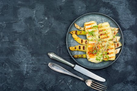 Photo for Appetizing appetizer of white asparagus and fried halloumi cheese. - Royalty Free Image