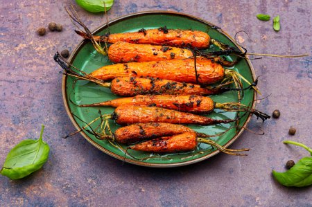 Photo for Baked with herbs and spices carrots. Tasty vegetable dish. - Royalty Free Image