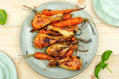 Photo for Grilled chicken drumsticks, roast chicken legs with carrots - Royalty Free Image