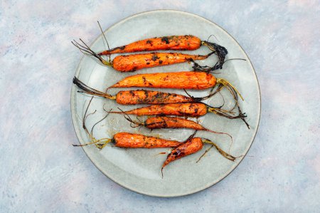 Photo for Fried carrots with herbs and spices on the plate. - Royalty Free Image