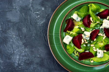 Photo for Salad with boiled beetroot, blue cheese, herbs and pine nuts. Diet detox raw food. Space for text - Royalty Free Image