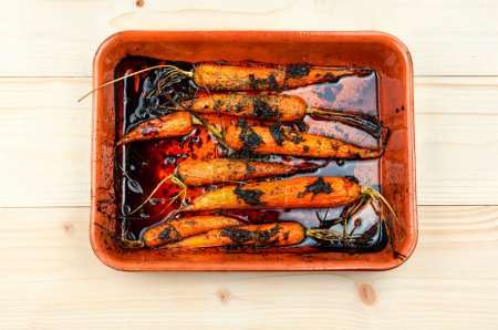 Photo for Baked carrots in a ceramic form. Top view - Royalty Free Image