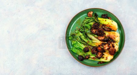 Photo for Chinese fried Pak Choi with shitake mushrooms. Asian vegan food. Space for text - Royalty Free Image