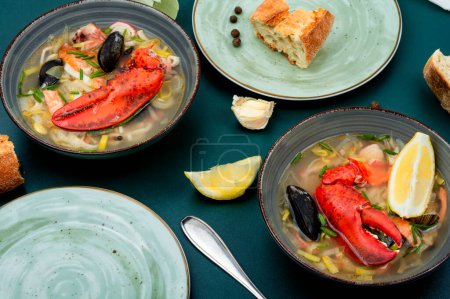 Photo for Tasty soup with lobster, shellfish, shrimps and fish. Seafood soup on the table - Royalty Free Image