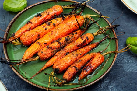 Photo for Baked, roasted carrots on ceramic plate. Tasty vegetable food. - Royalty Free Image