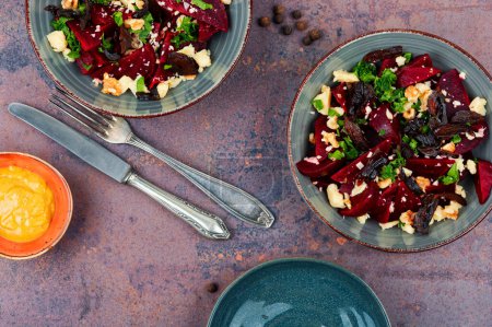 Photo for Diet salad of boiled beets, nuts and goat cheese on the plate. Flat lay. - Royalty Free Image
