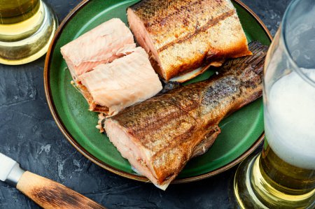 Photo for Tasty hot smoked trout salmon with beer - Royalty Free Image