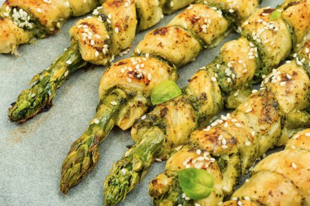 Photo for Delicious bread sticks stuffed with asparagus and pesto sauce on a plate. Close up. - Royalty Free Image