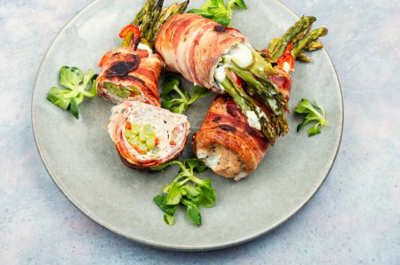 Photo for Grilled meatloaf wrapped in bacon. Meat stuffed with asparagus and cream cheese. - Royalty Free Image