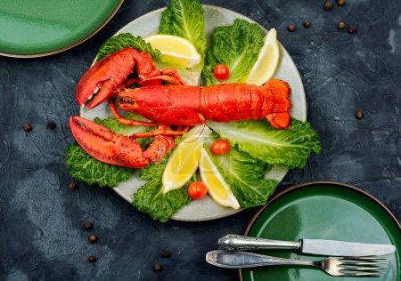 Photo for Cooked lobster with greens and lemon on a plate. Seafood. Top view. - Royalty Free Image