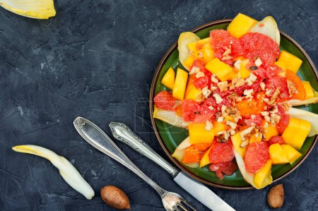 Photo for Freshly vitamin salad of grapefruit, mango and chicory. Copy space - Royalty Free Image