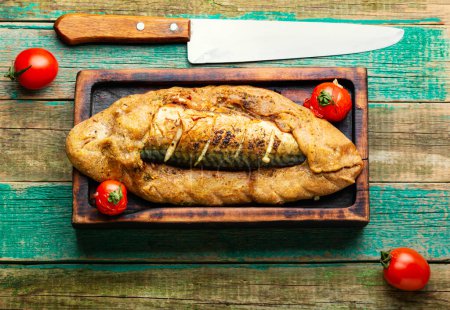 Photo for Delicious fish pie with mackerel on wooden board. Fish baked in bread. - Royalty Free Image