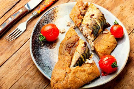 Photo for Pieces fish pie with mackerel on wooden board. Fish baked in bread. - Royalty Free Image