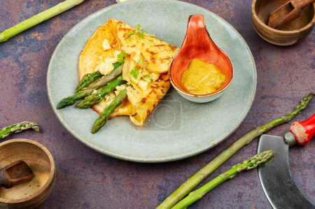 Photo for Homemade omelet stuffed with green asparagus and herbs. healthy food. - Royalty Free Image