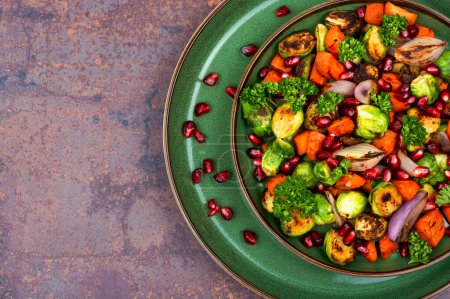 Photo for Varicoloured salad with Brussels sprouts, carrots, decorated with herbs and pomegranate. Top view with copy space - Royalty Free Image